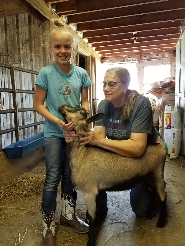 Another 2018 IDGA Share-A-Kid winner and donor! Judi Nayeri of Ma's Acres has donated an Alpine doeling to Eleanor Shinn, age 10, of Clarke County. Pictured are Eleanor, doeling Taylor, and Judi.